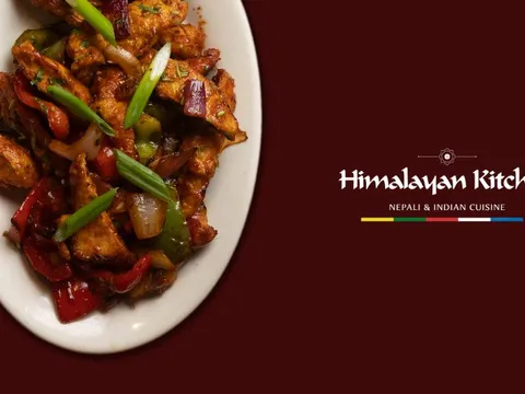Spiced chicken with peppers and onions beside the Himalayan Kitchen wordmark