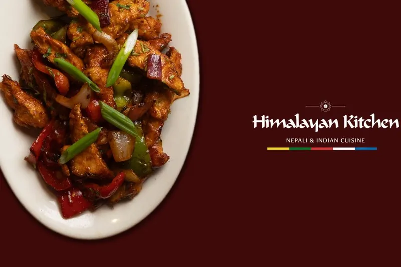 Spiced chicken with peppers and onions beside the Himalayan Kitchen wordmark