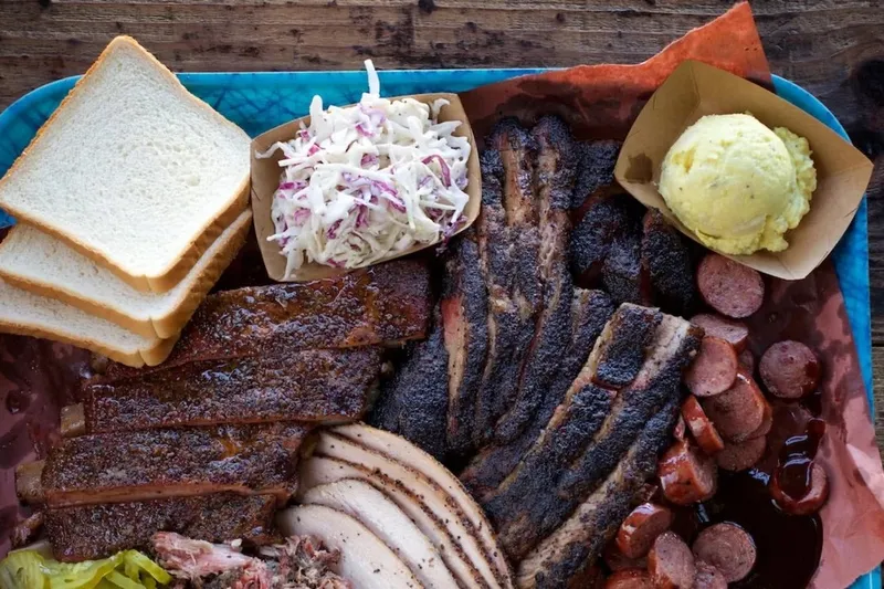 Tray of brisket, ribs, turkey, and sausage at Franklin Barbecue