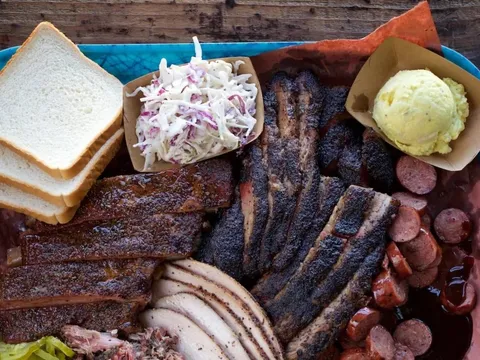 Tray of brisket, ribs, turkey, and sausage at Franklin Barbecue