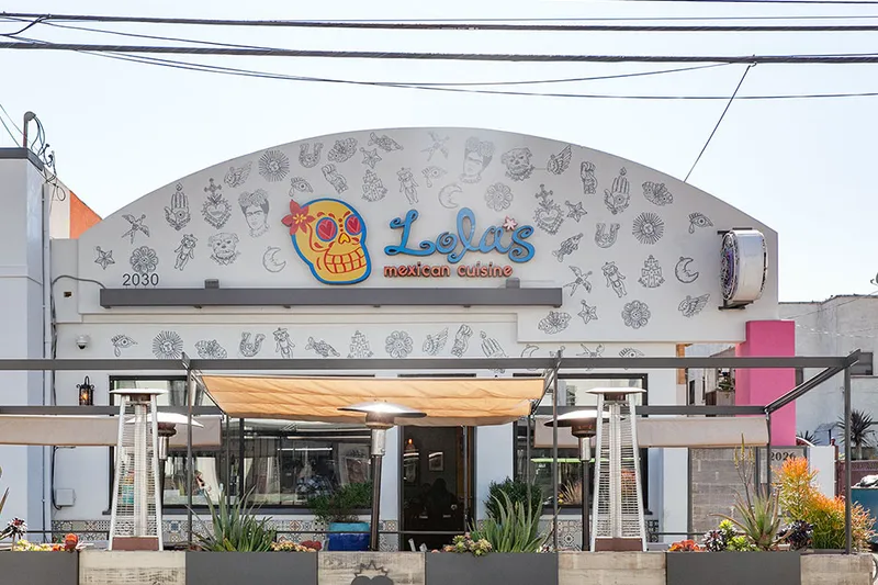 Storefront of Lola's Mexican Cuisine on Retro Row in Long Beach, with its sugar-skull sign and covered patio