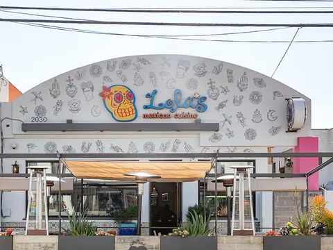 Storefront of Lola's Mexican Cuisine on Retro Row in Long Beach, with its sugar-skull sign and covered patio