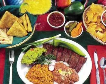 Old Town Mexican Cafe carne asada plate with sliced grilled steak, guacamole, Mexican rice, refried beans, a grilled chile, quesadilla wedges, chips and salsa