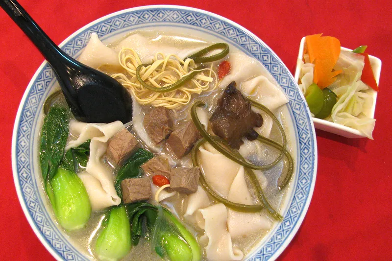 Bowl of Henan hand-pulled wide noodle soup with beef and bok choy at Uncle Zhou