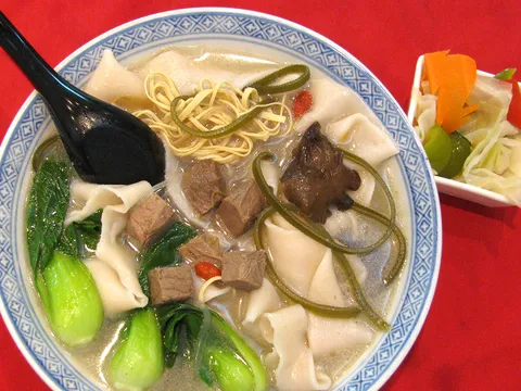 Bowl of Henan hand-pulled wide noodle soup with beef and bok choy at Uncle Zhou
