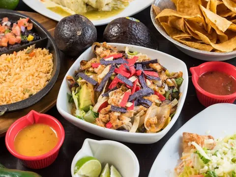 Platter of tacos with rice, guacamole and salsas at Tomatillos