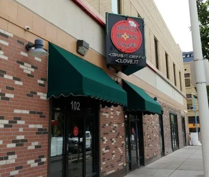 Storefront of Baca Boys Cafe at 102 4th Street NW with green awnings and a hanging sign