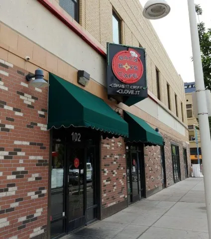 Storefront of Baca Boys Cafe at 102 4th Street NW with green awnings and a hanging sign