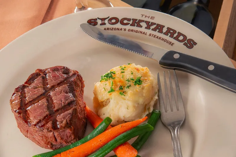 Filet mignon with twice-baked potato and vegetables at The Stockyards