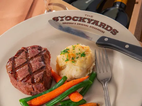 Filet mignon with twice-baked potato and vegetables at The Stockyards