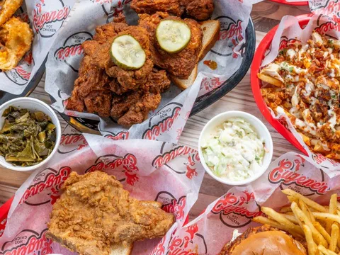Baskets of fried hot chicken with sides of greens, slaw and fries at Eugene's Hot Chicken