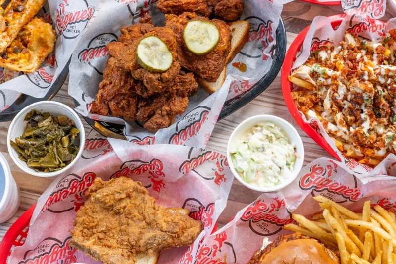 Baskets of fried hot chicken with sides of greens, slaw and fries at Eugene's Hot Chicken