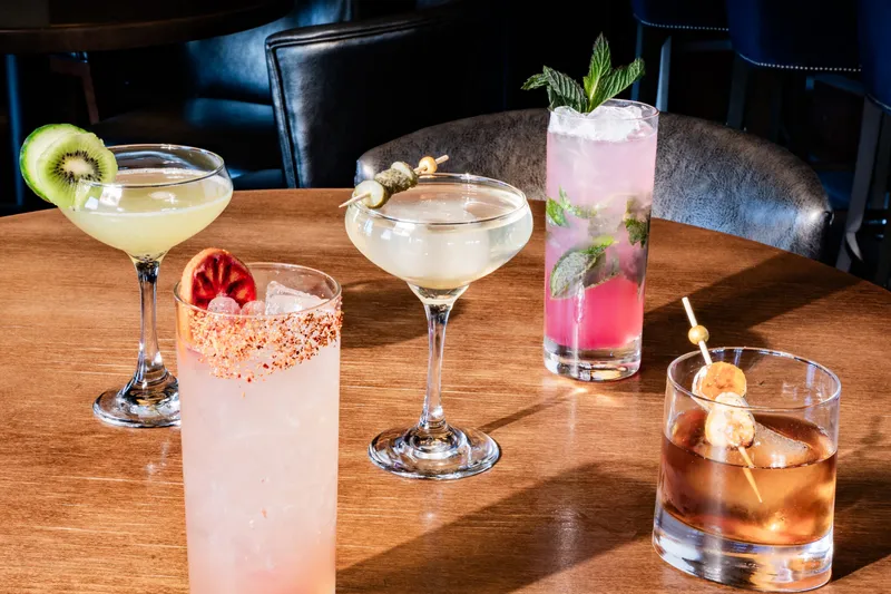 A spread of craft cocktails on a table at The Republic on Grand