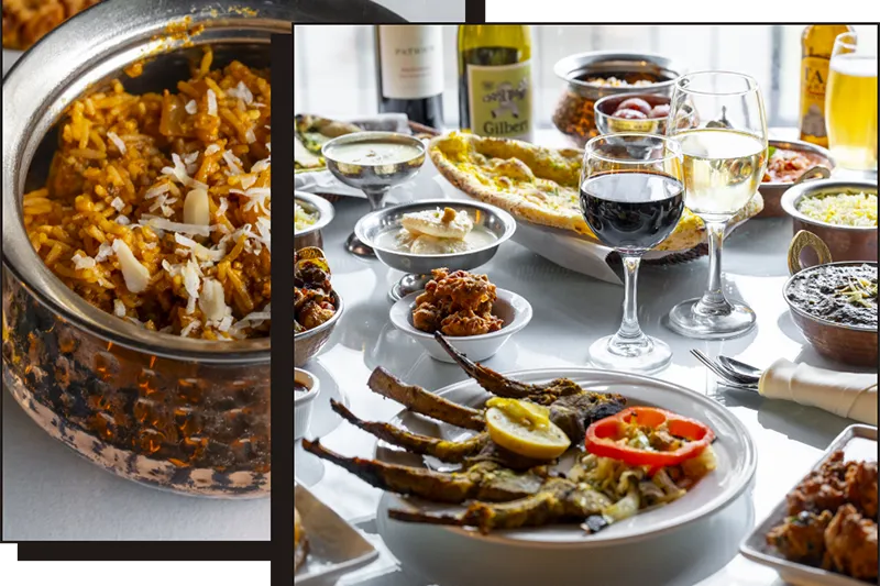 Biryani, wine and assorted Indian dishes plated at India Bistro in Ballard