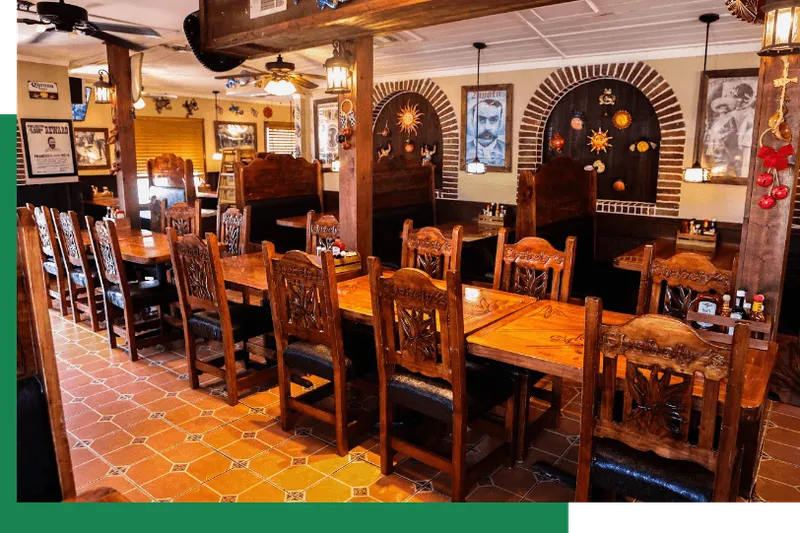 Carved wooden tables and chairs in the dining room at Chabely's Mexican Grill