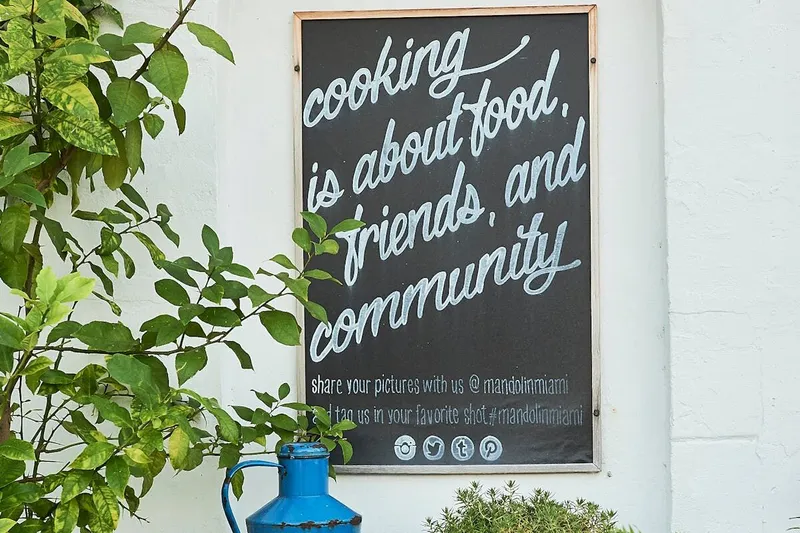 Mandolin Aegean Bistro wall sign about food, friends, and community