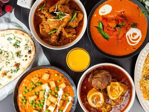 A spread of naan, curries, rice, and grilled dishes from Sabri Nihari.