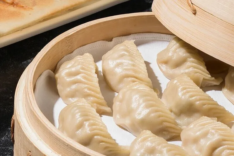 Steamed dumplings in a bamboo basket at Din Tai Fung Century City