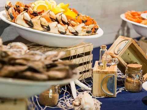 Raw bar seafood spread of stone crab claws, oysters and shrimp at Monty's Raw Bar in Coconut Grove, Miami