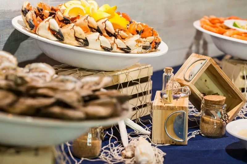 Raw bar seafood spread of stone crab claws, oysters and shrimp at Monty's Raw Bar in Coconut Grove, Miami