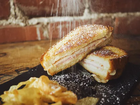 Grilled Monte Cristo sandwich dusted with powdered sugar at The Wheel Barrel