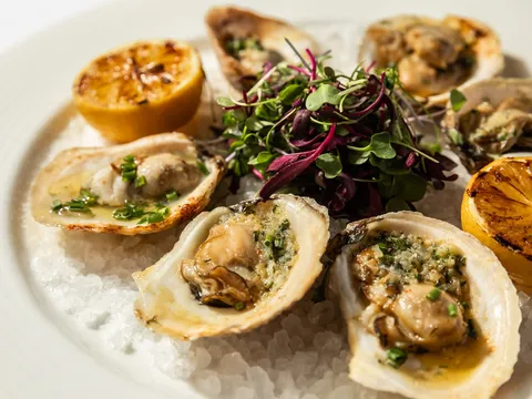 Char-grilled oysters on an open flame at Bridgeman's Chophouse