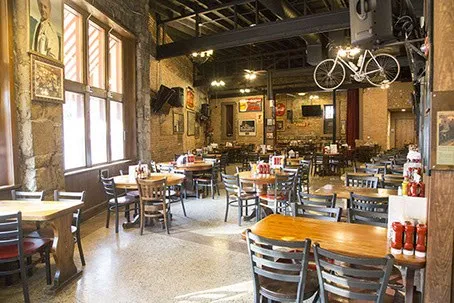 Dining room interior with wooden tables at Manuel's Tavern