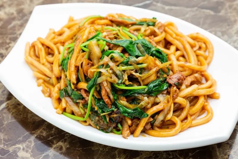 Plate of stir-fried noodles with greens at Joe's Shanghai