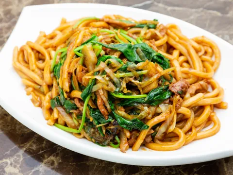Plate of stir-fried noodles with greens at Joe's Shanghai