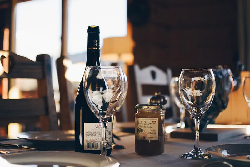 Dining table set with wine glasses inside Gene's Chinese Flatbread Cafe