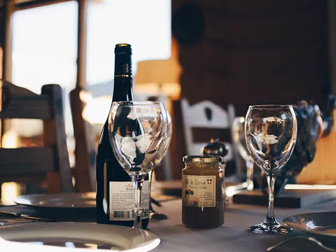 Dining table set with wine glasses inside Gene's Chinese Flatbread Cafe