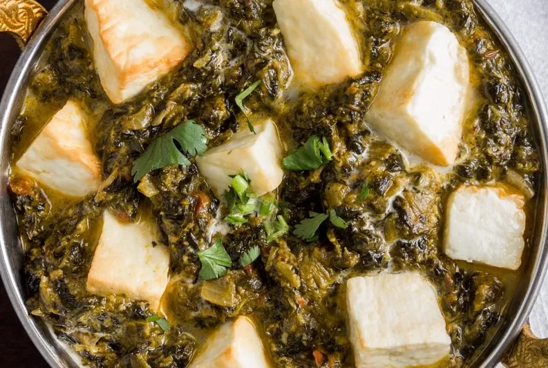 Saag paneer served in a copper karahi at Bhatti Himalayan Grill