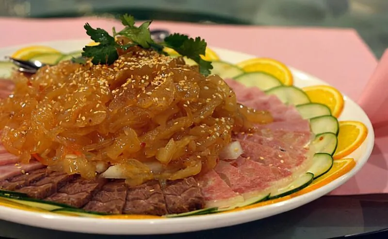 Top Gun Appetizer Platter at Top Gun Seafood Restaurant — jellyfish, sliced beef shank and ham with cucumber and orange garnish