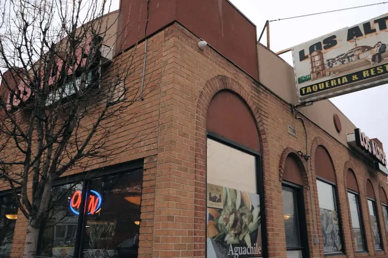 The brick corner storefront of Los Altos Taqueria & Restaurant at 7056 West Vernor Highway, with its painted overhead sign and neon Open sign