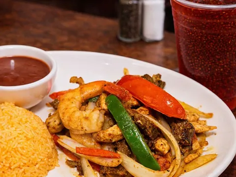 Mixed fajita plate of chicken, beef and shrimp with yellow rice and refried beans at El Rinconcito Café in Washington, DC