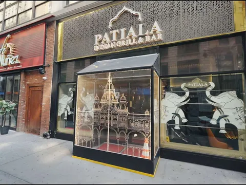 Gold-lettered storefront of Patiala Indian Grill & Bar on West 35th Street, with etched-elephant windows