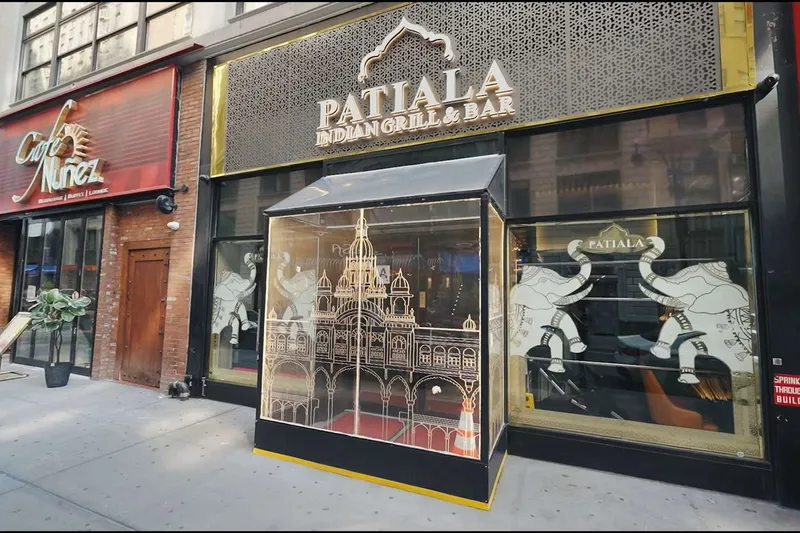 Gold-lettered storefront of Patiala Indian Grill & Bar on West 35th Street, with etched-elephant windows