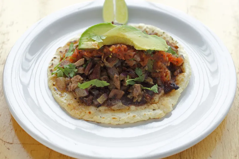 Taco de poc-chuc — grilled marinated pork with black beans, salsa roja, cilantro and avocado on a handmade tortilla — at Poc-Chuc in San Francisco