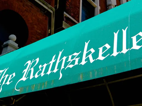 Green awning reading "The Rathskeller" over the restaurant's entrance