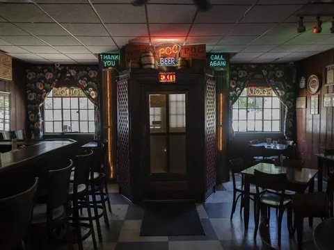Interior of Prosperity Social Club with vintage neon signage