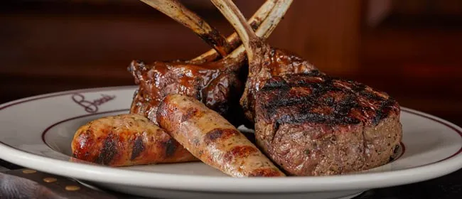 Plate of grilled sausages, lamb chops and filet at Bones Restaurant