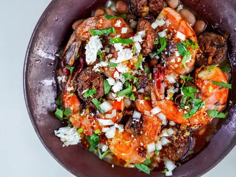Wood-fired Sonoran dish with roasted vegetables and fresh garnishes at Bacanora