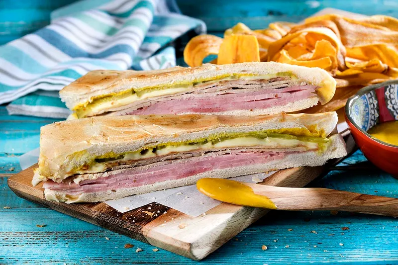 Cuban sandwich with ham, roast pork and Swiss cheese, served with plantain chips, at La Carreta