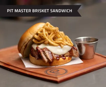 Pit Master Brisket Sandwich with crispy onion straws at Q39