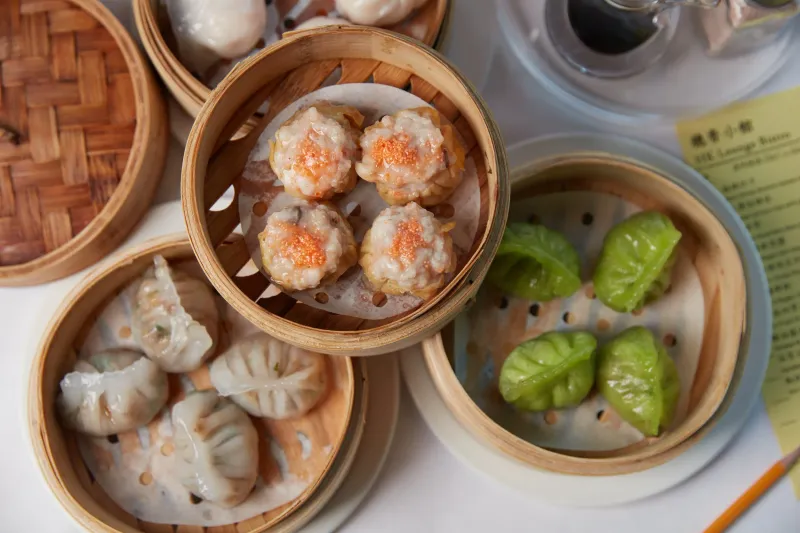 Assorted dim sum in bamboo steamers — siu mai, dumplings and spinach dumplings — at HK Lounge Bistro
