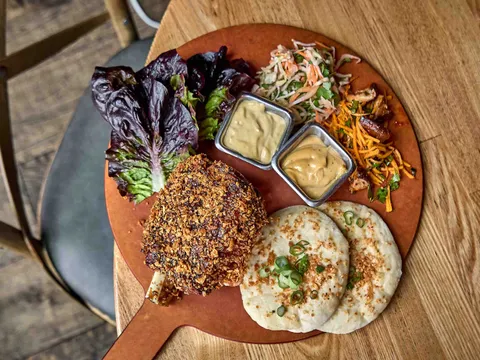 Crispy pork shank with lettuce cups and flatbread at Girl & the Goat