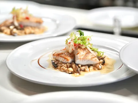 A plated seafood dish over risotto from Andiamo in Banca in South San Francisco.