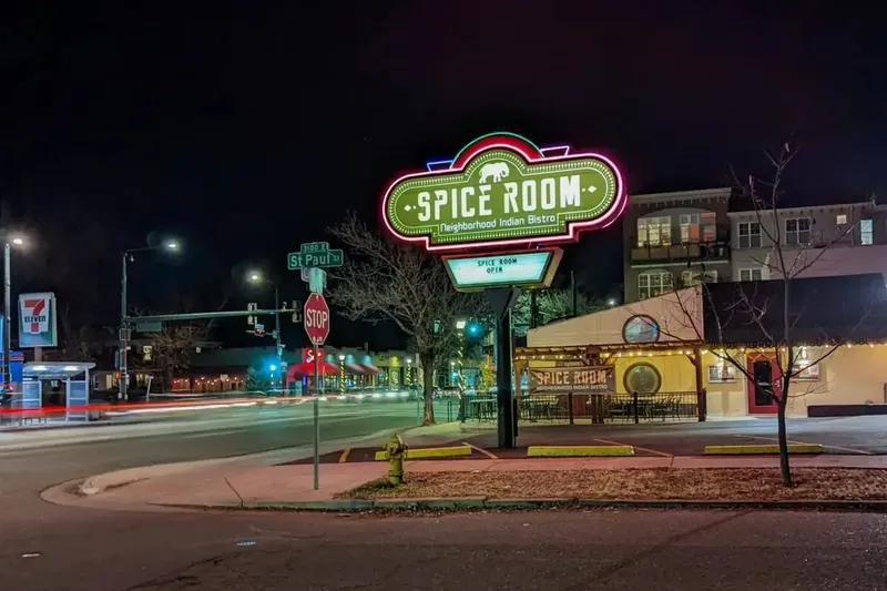 Spice Room Bluebird District exterior and illuminated sign at night