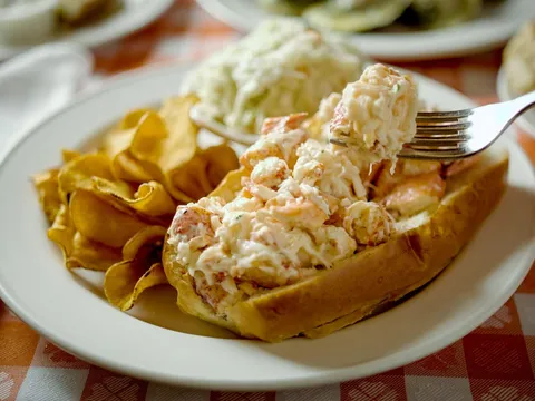Lobster roll with coleslaw and chips at Grand Central Oyster Bar