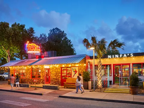 Lit exterior and patio of Ninfa's on Navigation at dusk